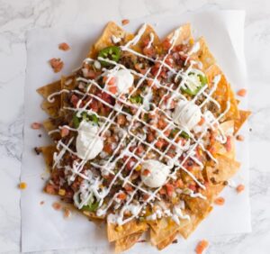 Dumpster Fire Nachos. The perfect party food for any gathering, piled high with all kinds of junk, including fiery jalapeno ranch.
