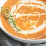 With red peppers, tomatoes, garlic and fresh herbs, this easy, creamy roasted red pepper and tomato soup is my favorite way to warm up on a cold day.