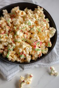 This sweet and salty popcorn recipe is made using white chocolate. It makes the perfect movie night snack, party favor, or christmas gift!