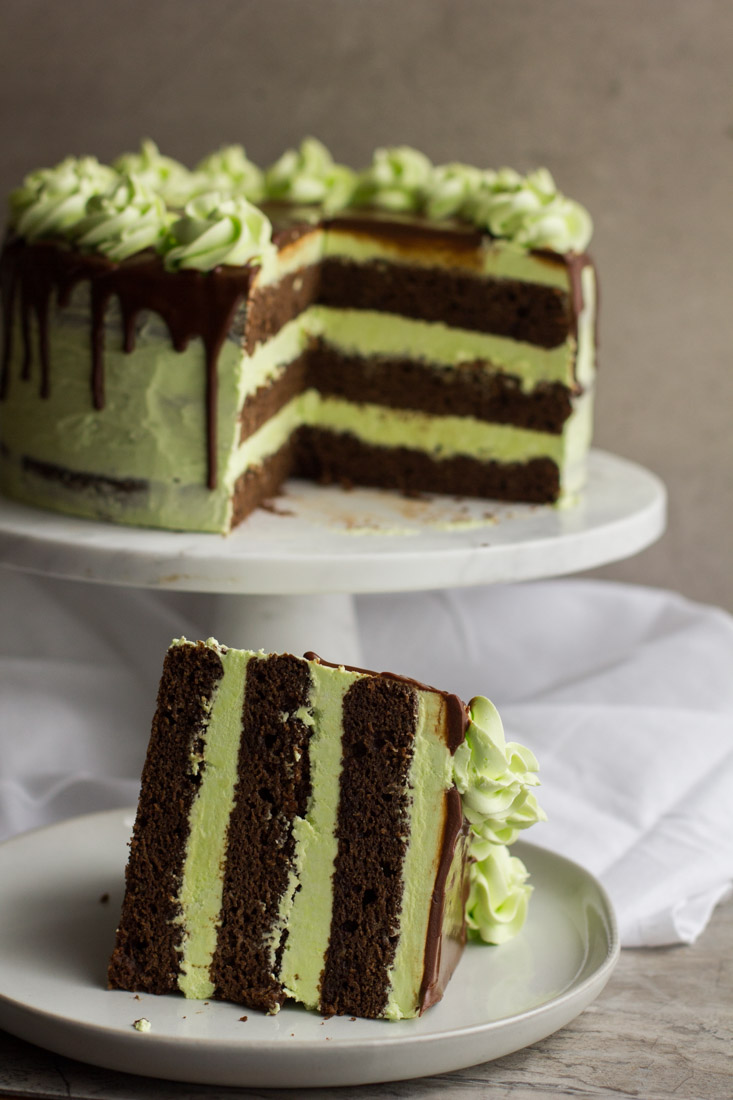 a mint julep cake with a slice taken out and put on a plate