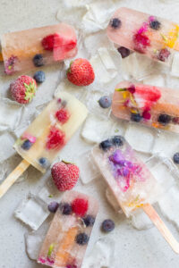 several fruity popsicles on a table