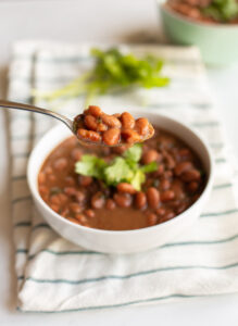 Close up of a spoonful of instant pot charro beans
