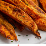 These roasted sweet potato wedges are a sweet and spicy easy side dish. They're perfectly paired with burgers, steak, meatloaf and chili and a great dish to bring to a bbq or cookout.