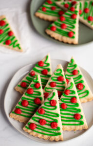 shortbread cookies cut into triangles and iced to look like christmas tree cookies