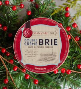 joan of arc double creme brie on a holiday themed background