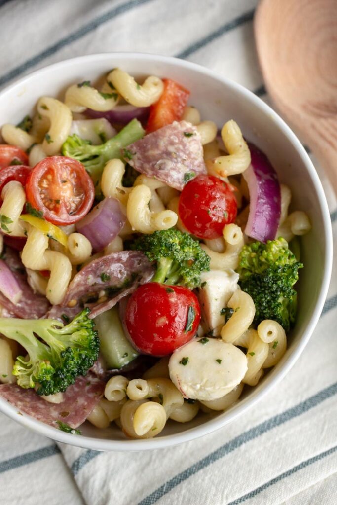 Italian pasta salad with cavatappi pasta, tomatoes, broccoli, peppers, salami and cheese