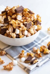 s'mores popcorn with mini marshmallows and chocolate grahams in a bowl