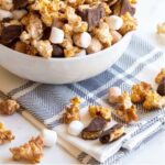 S'mores popcorn is a fun twist on traditional popcorn with marshmallows, chocolate covered grahams and a dusting of cocoa. Perfect for snacking on summer movie nights!