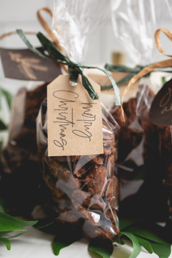 spicy candied pecans in cellophane bags with ribbon and a gift tag