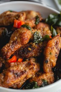 close up of fried chicken wings tossed in garlic sauce