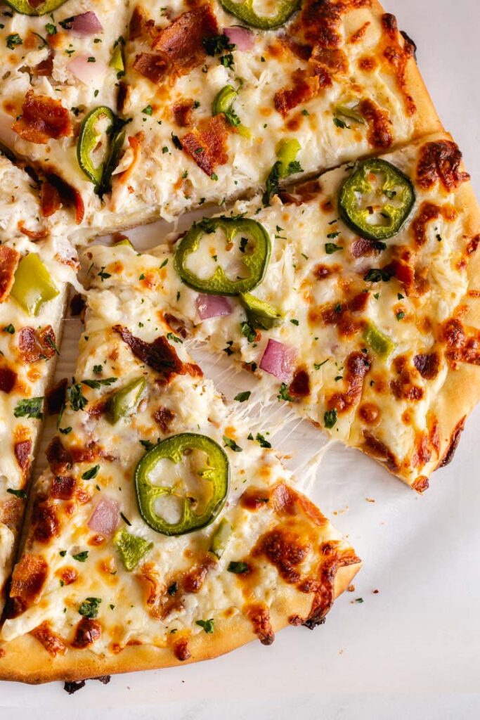 crab pizza topped with bacon, jalapeno and cheese