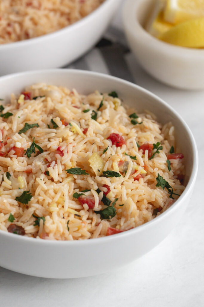basmati rice pilaf in a bowl garnished with parsley