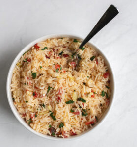 basmati rice pilaf in a bowl with a spoon sticking out